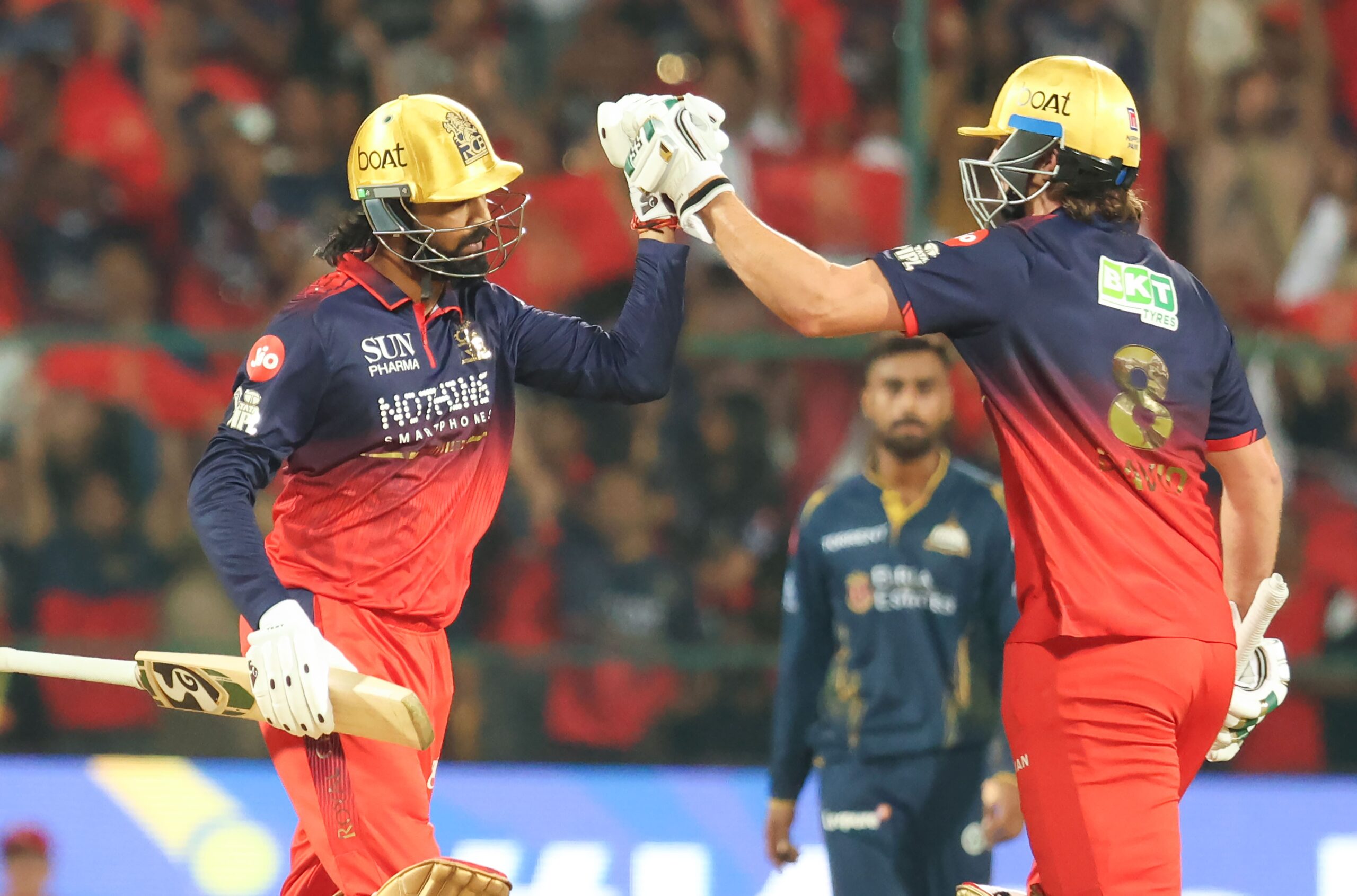 Gujarat Titans and Royal Challengers Bengaluru players in action highlighting Ahmedabad pitch, weather, and key player battle in IPL 2026.