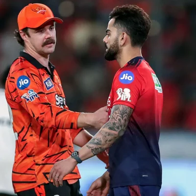 Virat Kohli and Travis Head during a tense IPL 2026 post-match moment that sparked handshake controversy discussions.